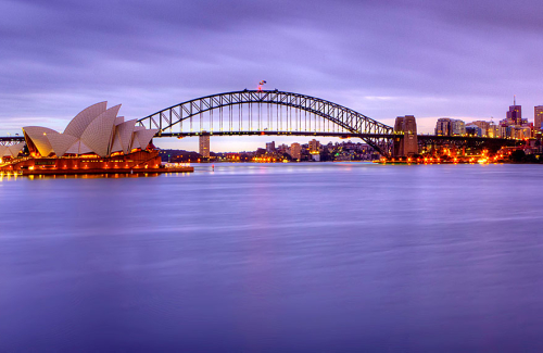 A Pre-dawn photo of Sydney Harbour, overlooking the Opera House and Harbour Bridge